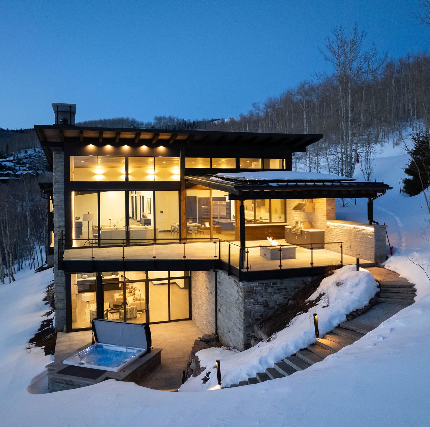 Early stages of luxury home construction with concrete foundation walls and heavy equipment in Avon, Colorado