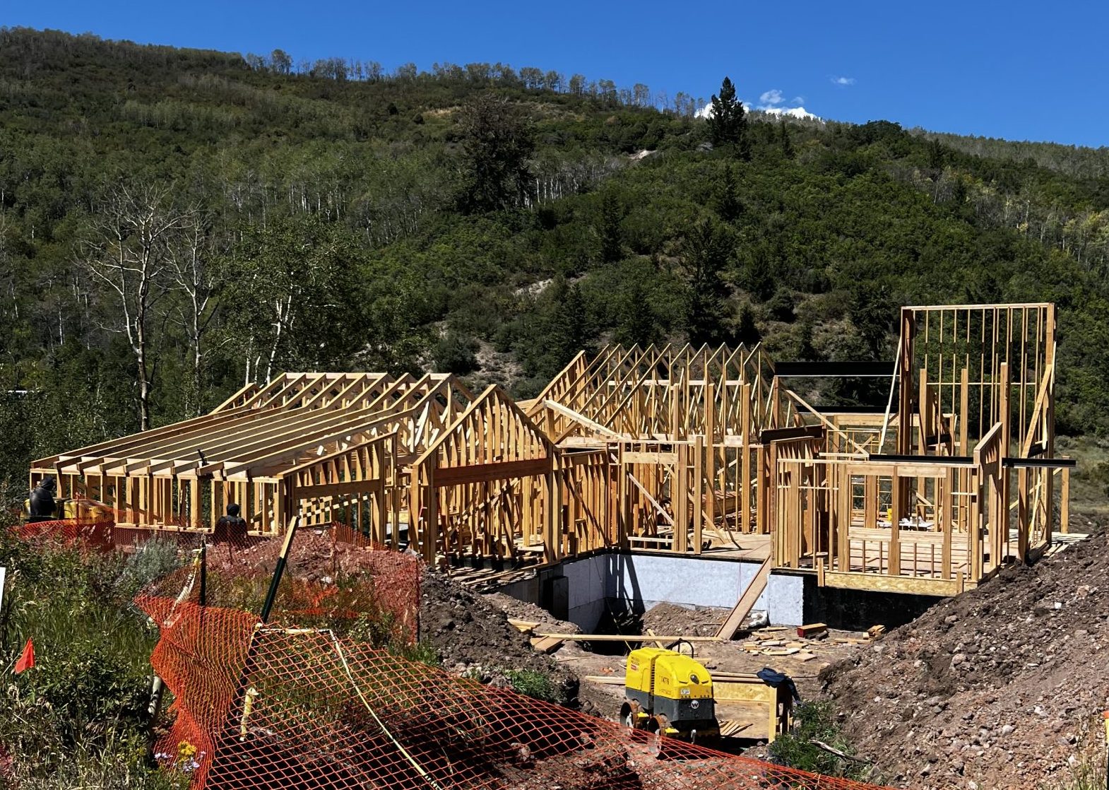 Framing stage of a custom luxury home under construction in the mountains of Avon, Colorado by H&C Construction