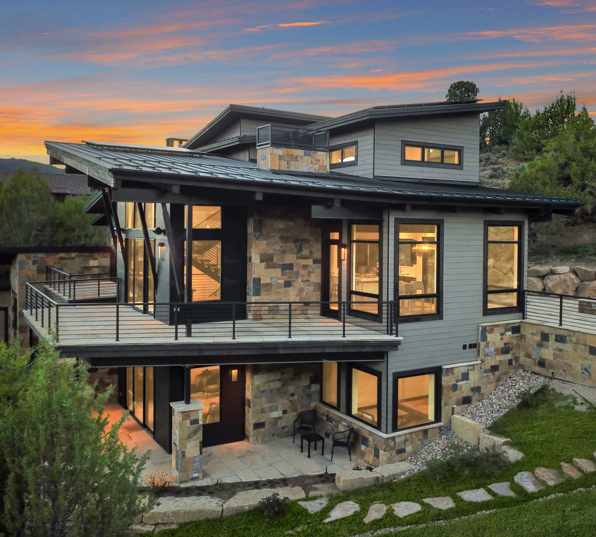 Early stages of luxury home construction with concrete foundation walls and heavy equipment in Avon, Colorado