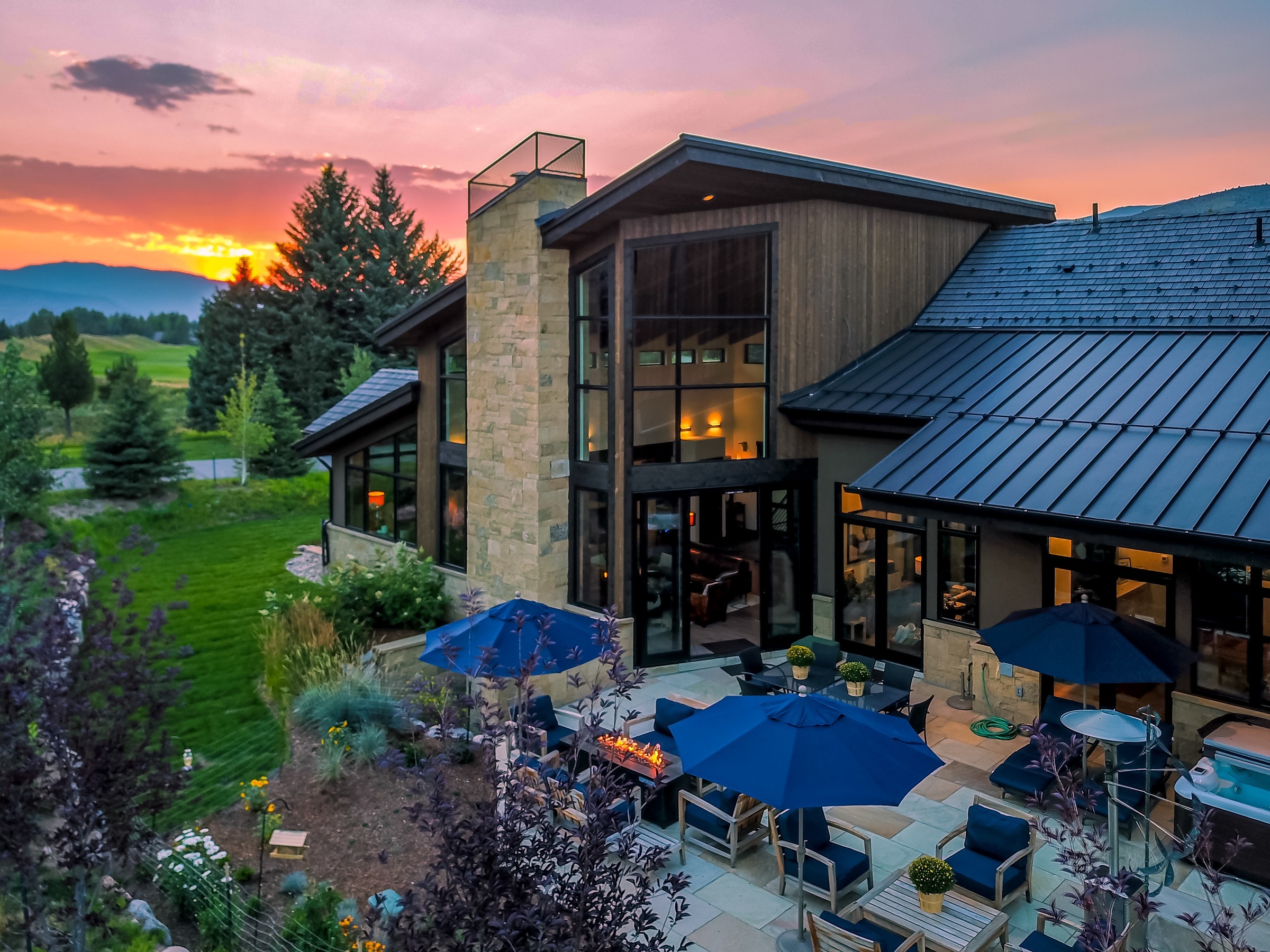 Early stages of luxury home construction with concrete foundation walls and heavy equipment in Avon, Colorado