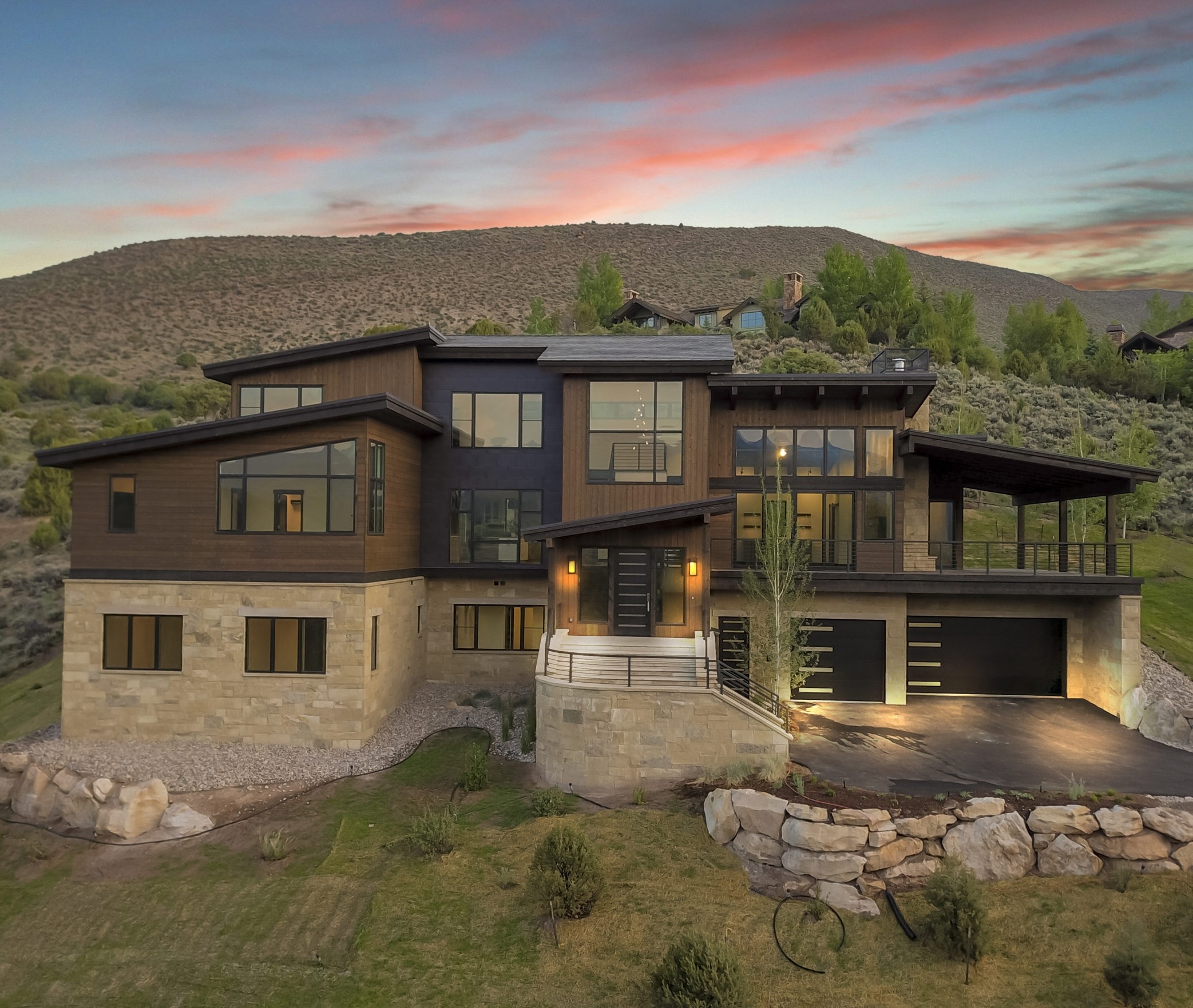 Early stages of luxury home construction with concrete foundation walls and heavy equipment in Avon, Colorado