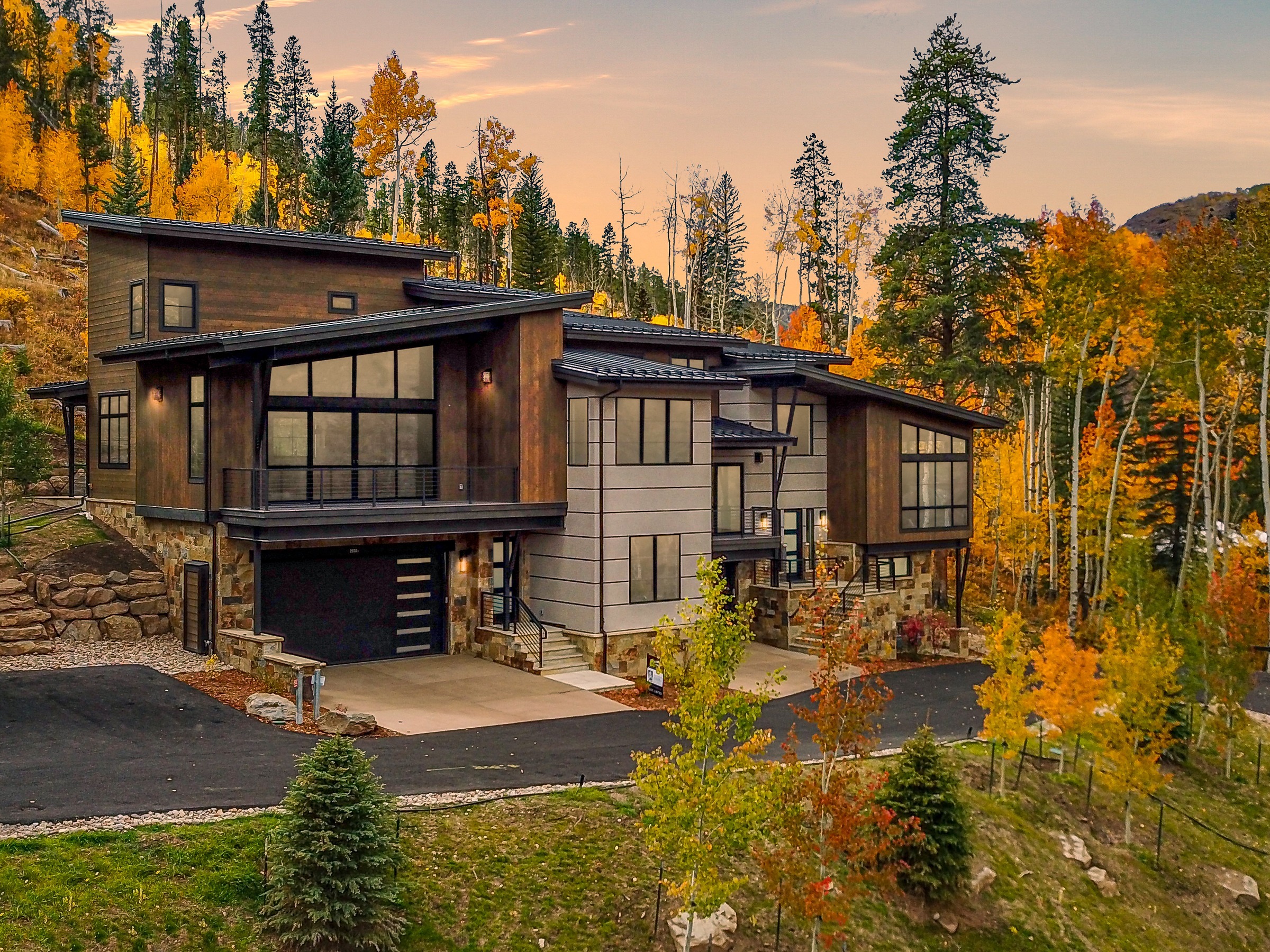Early stages of luxury home construction with concrete foundation walls and heavy equipment in Avon, Colorado